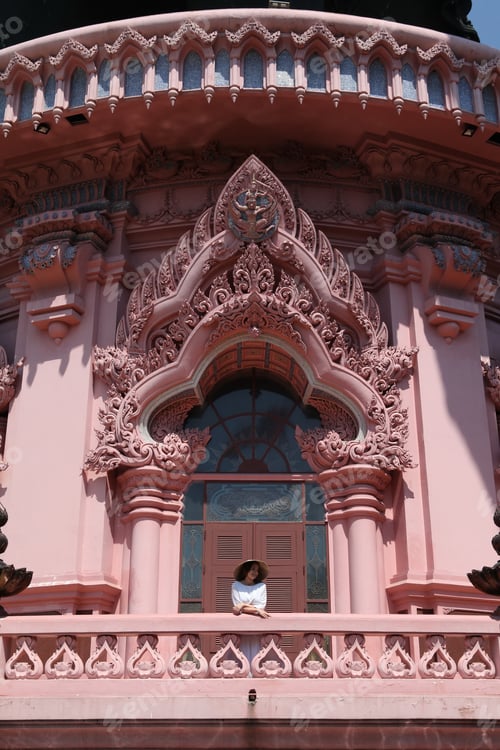 Preview: Erawan Museum In Bangkok City, Thailand, And Tourist Girl In Asian Hat. Pink Windows Of Erawan