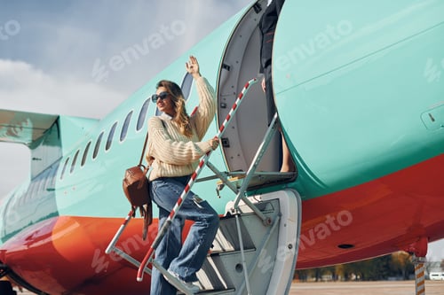 Preview: At daytime. Young female passanger in casual clothes is outdoors near the plane