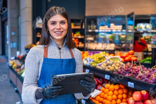 Preview: Greengrocer woman managing inventory with digital tablet