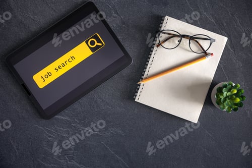 Preview: Top view of digital tablet with search job on screen on a table.