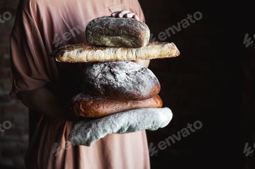 Preview: Fresh bread in the hands of a baker. Food, baking