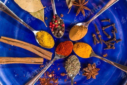 Preview: Different colorful spices on dark blue background