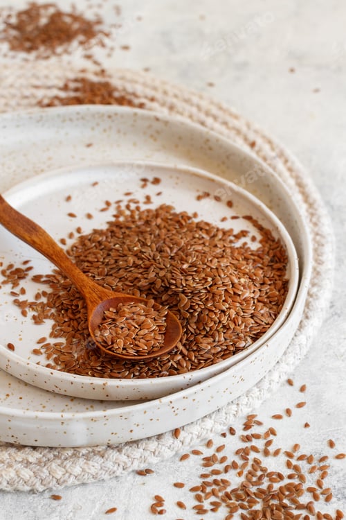 Preview: Raw Flax seeds on a ceramic plate with a spoon