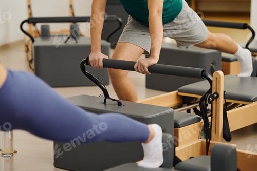 Preview: Engaging in dynamic pilates exercises at a modern studio for enhanced fitness and flexibility
