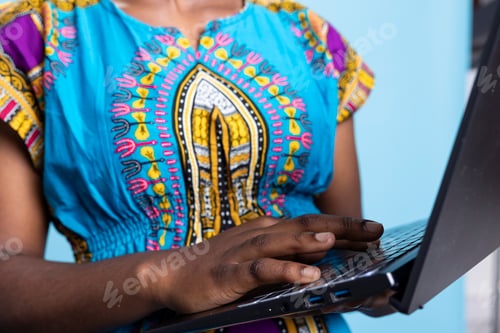 Preview: African american model navigating on internet webpages over blue background