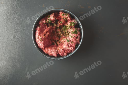 Preview: Top view on minced meat with spices in blue ceramic