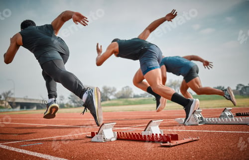 Preview: Rearview shot of three unrecognizable young male athletes starting their race on a track