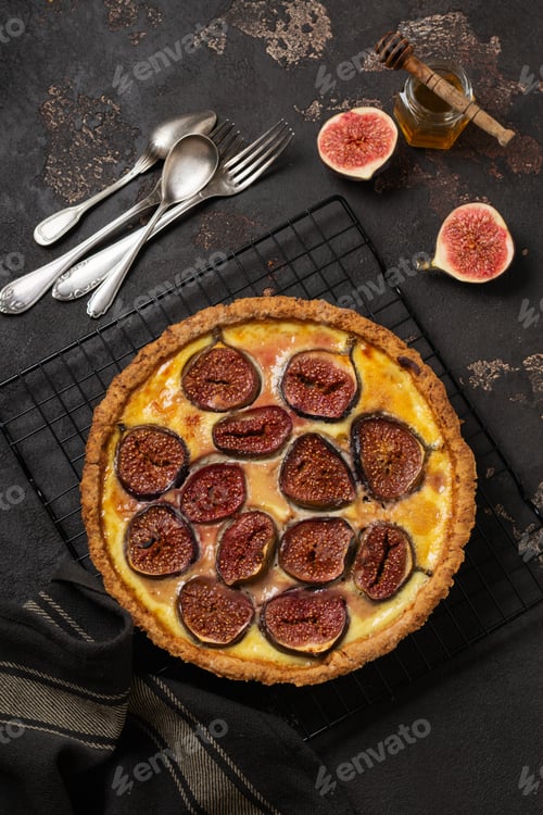Preview: Homemade quiche tart with figs, cream cheese and honey on dark brown background. Vintage style. Top