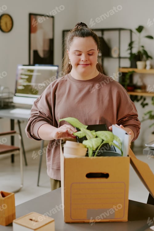 Preview: Smiling Woman Looking at Plant in Box