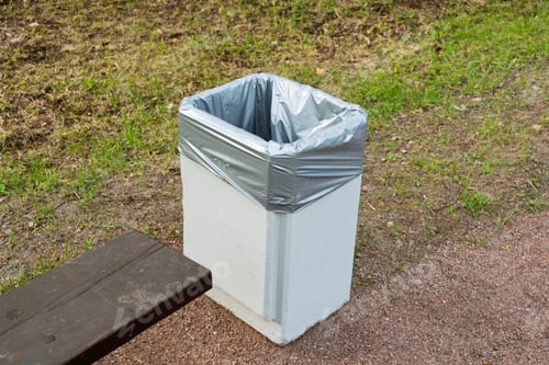 Preview: Public park trash bin with plastic liner placed next to wooden bench