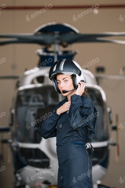 Preview: Pilot girl poses with her helicopter.