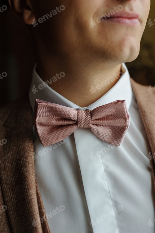 Preview: Tie butterfly on the neck of the groom. Close-up.