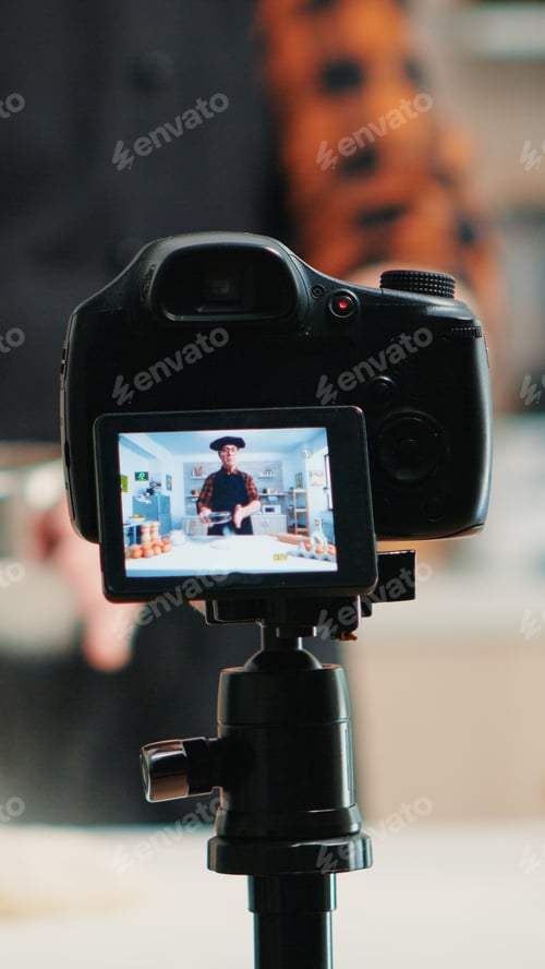 Preview: Video camera filming man in kitchen