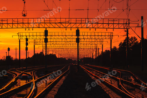 Preview: Dark Silhouettes Railway Infrastructure In Dramatic Sunset Backl
