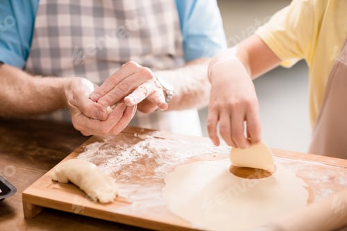 Preview: grandchild and grandfather cooking and making dough for cookies with kitchen utensils at kitchen