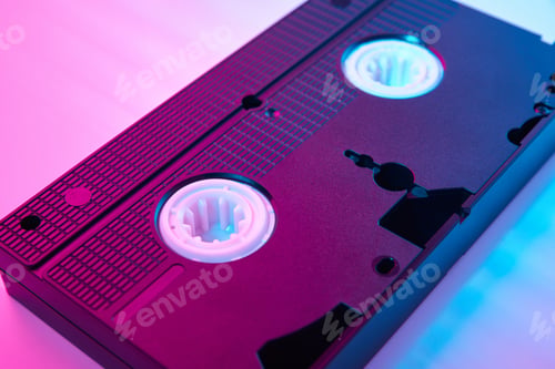 Preview: Video cassete on the color background. Retro vhs cassette tape