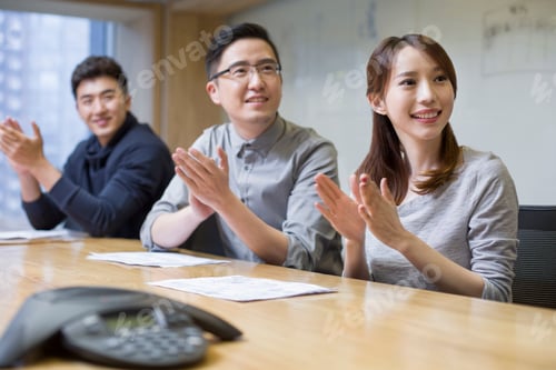 Preview: Business people clapping in board room