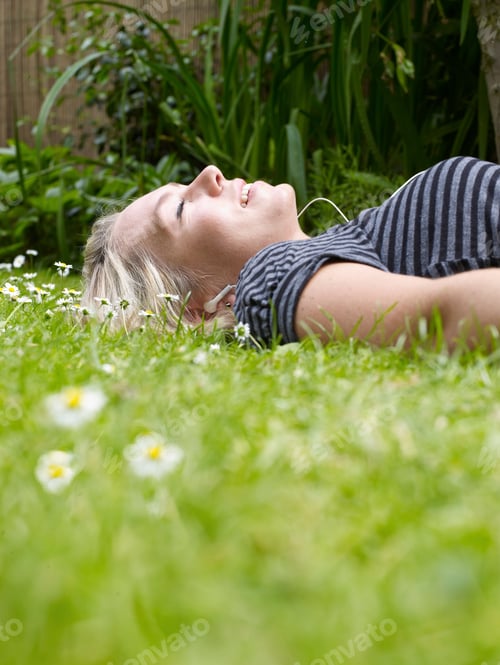 Preview: Smiling woman laying in grass
