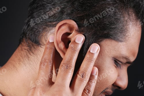 Preview: young man having ear pain touching his painful ear ,