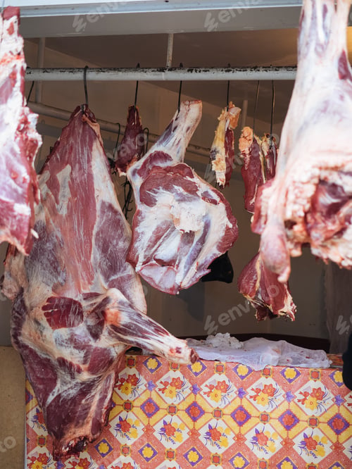 Preview: Pieces of red meat hangs on hook