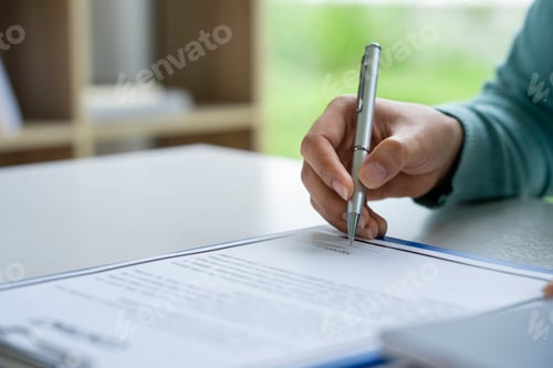 Preview: Businesswoman signing a document or application form in a folder, Woman signing document with pen on