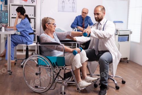 Preview: Medical therapist helping disabled senior woman