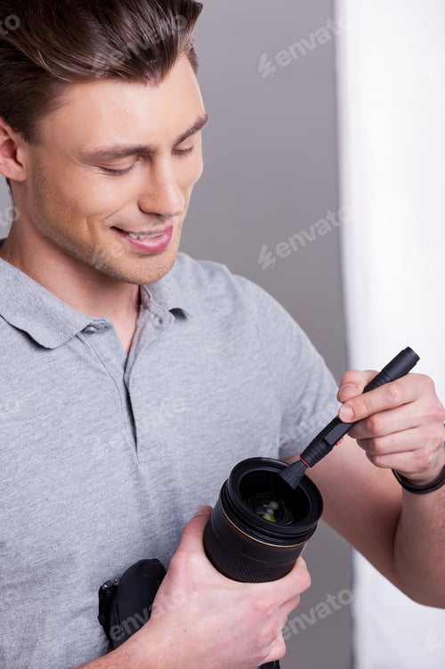 Preview: Photographer cleaning the lens.