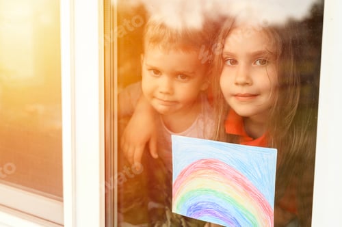Preview: kids siblings boy and girl with drawing rainbow looks through the window during covid-19 quarantine.