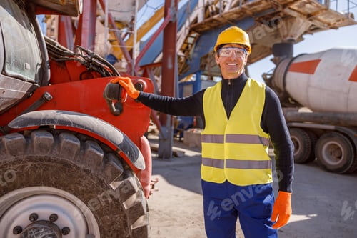Preview: Joyful male worker standing by vehicle at factory