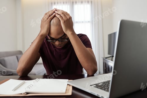 Preview: Stressed man at desk