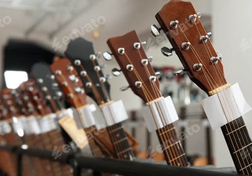 Preview: Row of different guitars in music store, closeup