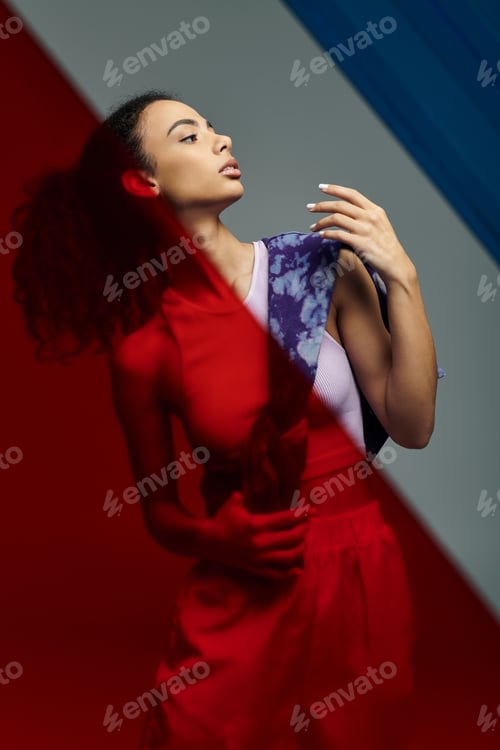 Preview: African american sportswoman posing in red light