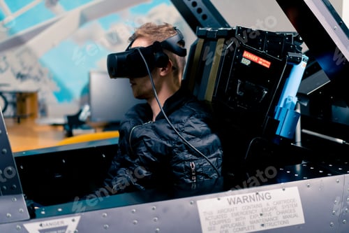 Preview: boy sitting in flight simulator military plane wearing virtual reality glasses flight entertainment