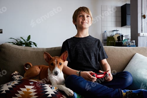 Preview: Smiling Boy Relaxing with His Dog on Couch