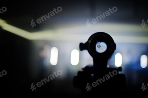Preview: Professional video camera lens on tripod background people on stage.
