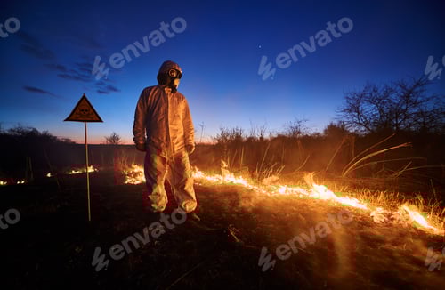 Preview: Firefighter ecologist working in field with wildfire.