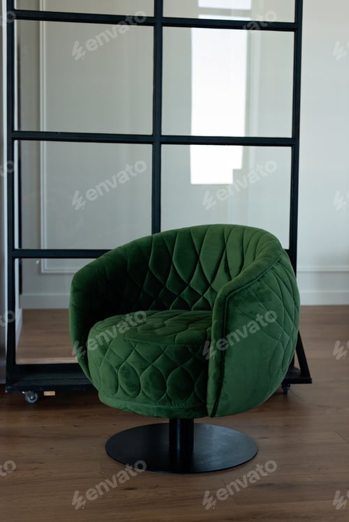 Preview: Stylish round green velvet armchair in a modern interior. Soft selective focus.