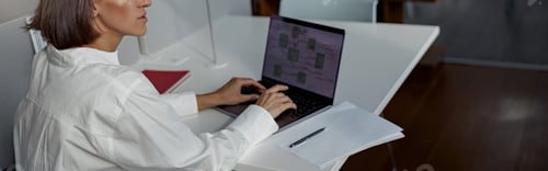 Preview: Focused european business woman working laptop while sitting in cozy cafe and looking away