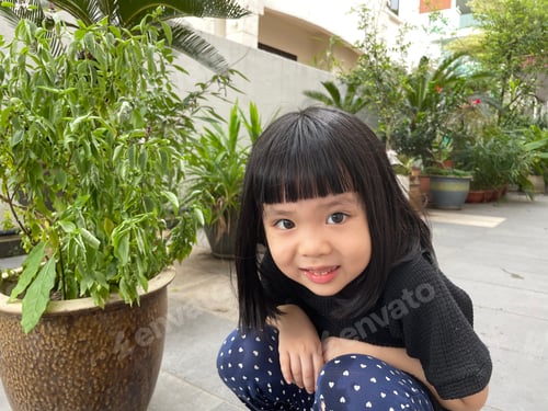 Preview: Asian girl plays with potted plants since she cannot go out due to pandemic