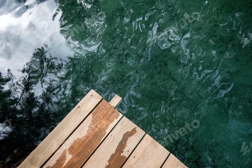 Preview: Tranquil Lake Setting with Wooden Path and Beautiful Tree Reflection