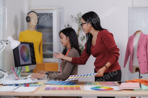 Preview: Fashion designers choosing colors for new clothes collection using color palettes