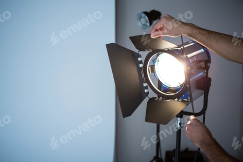 Preview: Photographer adjusting spotlight