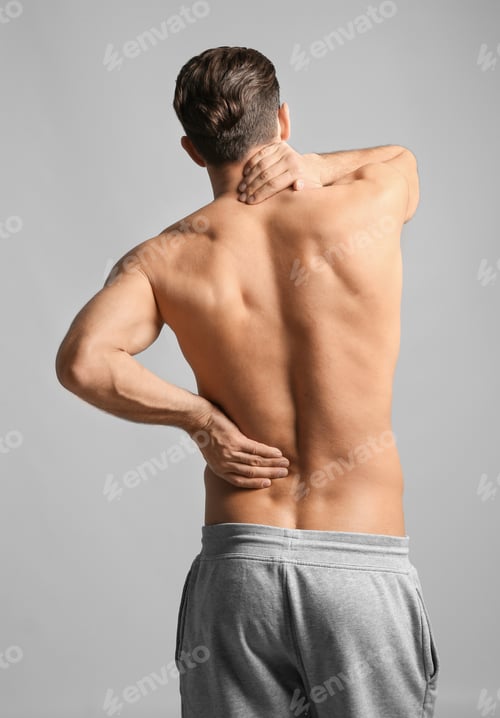 Preview: Young man suffering from neck pain on light background