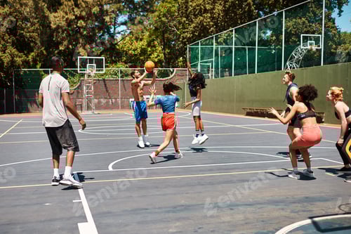 Preview: Court is in session. Shot of a group of sporty young people playing basketball on a sports court.