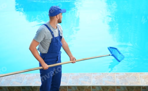 Preview: Male worker cleaning outdoor pool with scoop net
