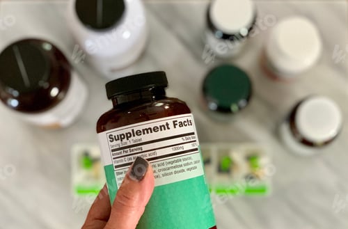 Preview: Reading the label on supplement pill bottle