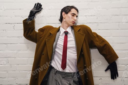 Preview: Charming man in stylish coat showcases modern fashion against a minimalist backdrop