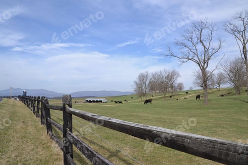 Preview: A beautiful expanse of farmland showing the heartland of America with fields, silos barns mountains