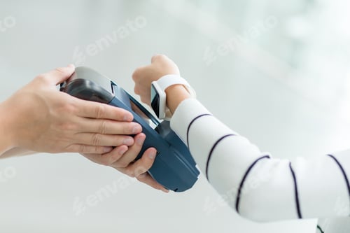 Preview: Woman pay by smartwatch by NFC technology