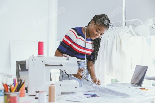 Preview: african black woman clothes designer costume artist happy working in clothing tailor made studio